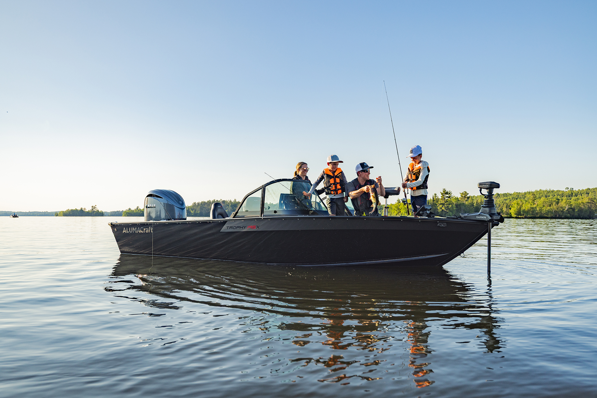 Man with his son fishing from an Alumacraft aluminum fishing boat