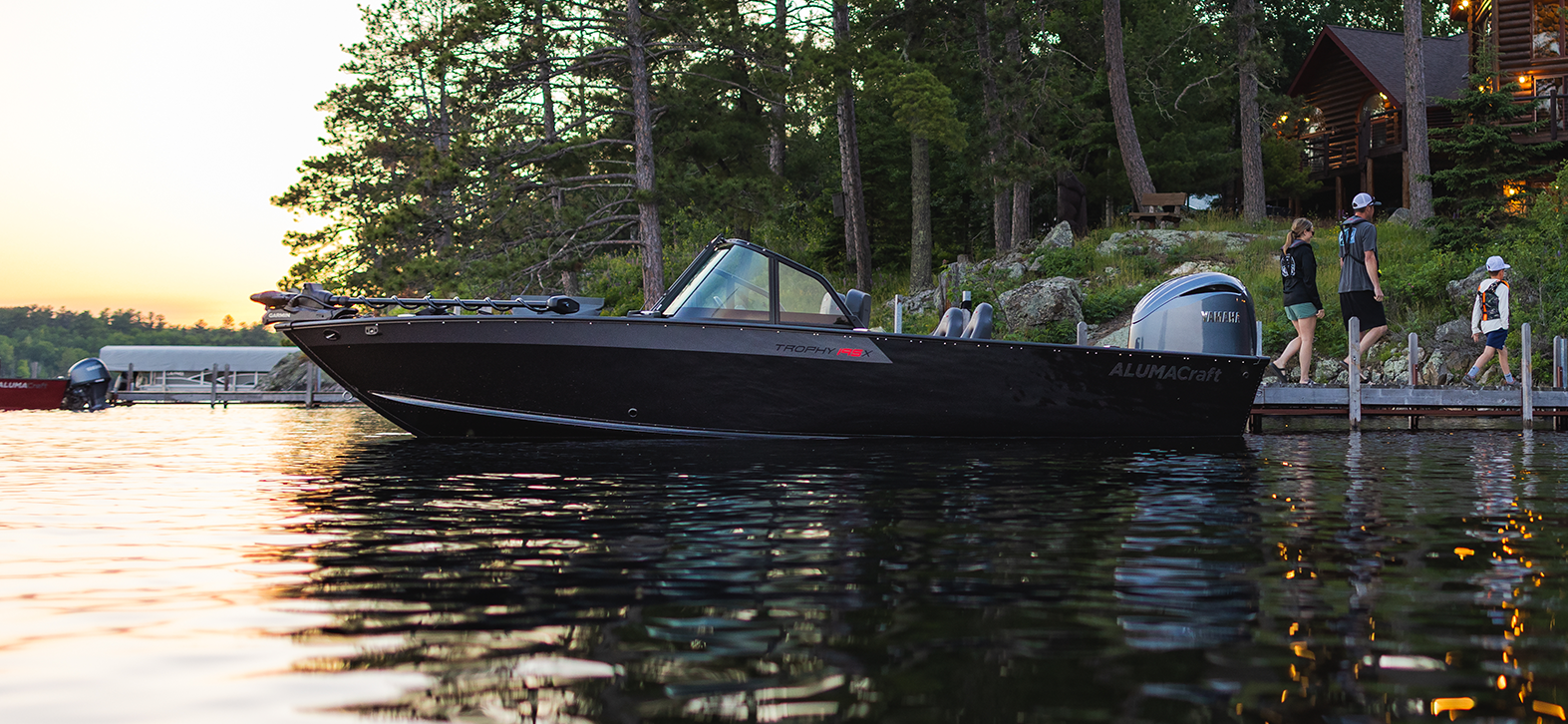 Man with his son fishing from an Alumacraft aluminum fishing boat